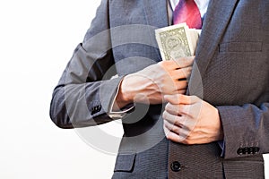 Business man hiding money in jacket pocket