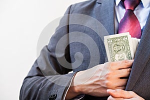 Business man hiding money in jacket pocket