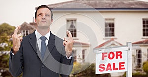 Business man with his fingers crossed, property sale