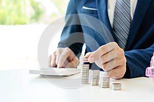 Business man hold collect coin in the row