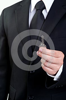 Business man hold key in isolated