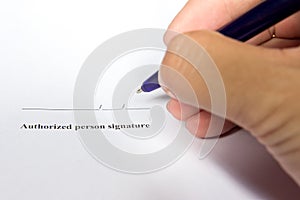 Business man hold the pen for sign in authorization signature