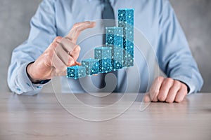 Business man holding 3D graphs low polygonal and stock market statistics gain profits. Concept of growth planning,business