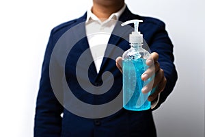 Business man holding alcohol gel bottle with white background