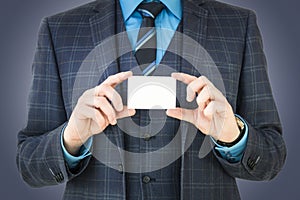 Business man holding business card with room for text and graphic.
