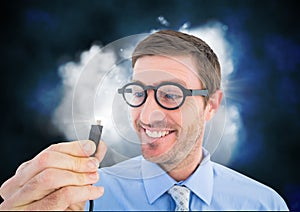 Business man holding a cable and flare against cloud