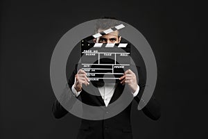 Business man holding a clapboard