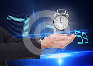 Business man holding a clock against background with clock