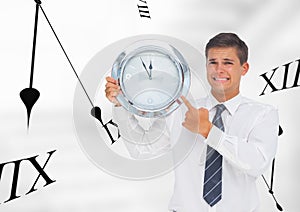 Business man holding a clock against background with clocks