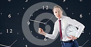 Business man holding a clock against background with clocks