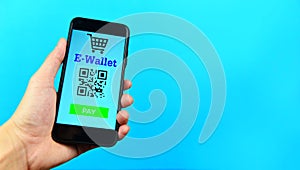 Business man holding e wallet app on smartphone technology pay on blue background - Mobile payment online shopping concept