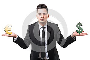 Business man holding euro and dollar symbols or signs