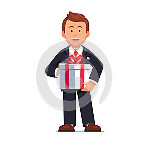 Business man holding gift box with red ribbon bow