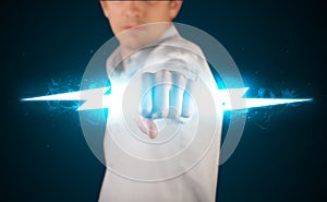 Business man holding glowing lightning bolt in his hands