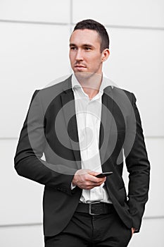 Business man holding in hands mobile phone