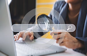 A business man holding magnifier and searching bar, technology and internet online concept