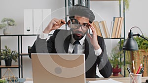 Business man holding magnifying glass near face, looking with big zoomed eye, searching, analysing
