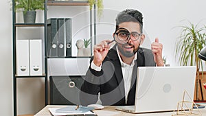 Business man holding magnifying glass near face, looking with big zoomed eye, searching, analyzing