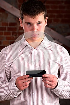 Business man holding a mobile communicator photo