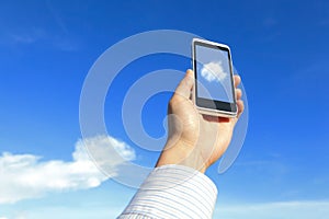 Business man holding mobile phone with cloud