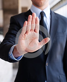 Business man holding out hand, indicating stop
