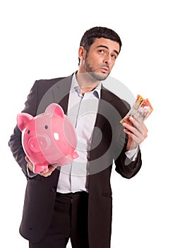 Business man holding piggy bank with Australian dollars