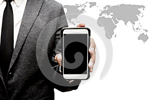 Business man holding smart phone with world map graphic