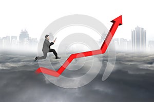Business man holding tablet jumping on red growth trend line