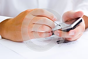 Business man holding a touchscreen mobile