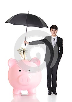 Business Man holding umbrella protect your money