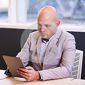 Business man holding and using a high tech tablet