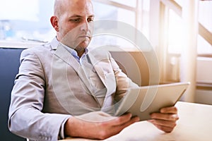 Business man holding and using a high tech tablet