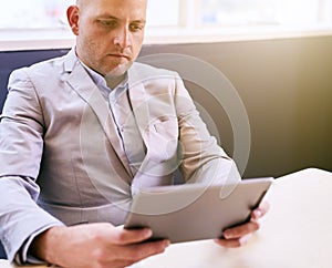 Business man holding and using a high tech tablet