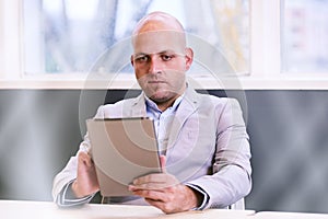 Business man holding and using a high tech tablet