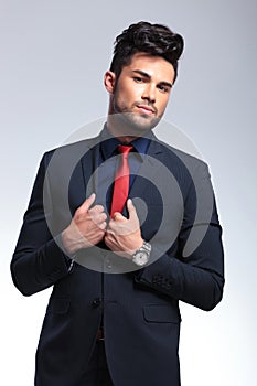 Business man holds hands on lapels photo