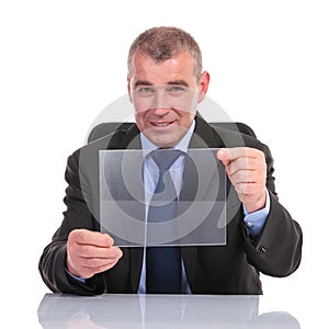 Business man holds a transparent pannel