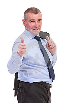 Business man with jacket over shoulder shows thumb up