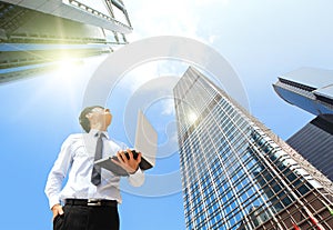 Business man with laptop and look sky and cloud