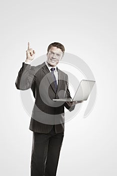 Business man with laptop showing thumbs up