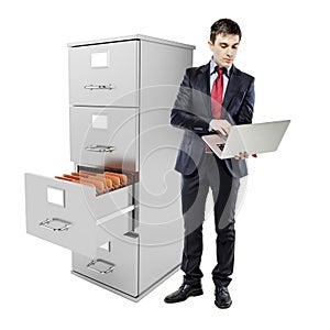 Business man with laptop standing near a 3d file c