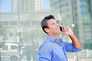 Business man laughing with mobile phone
