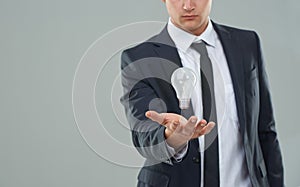 Business man, light bulb and ideas for company, entrepreneur with innovation and problem solving for energy saving