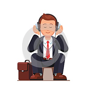 Business man listening to music and sitting