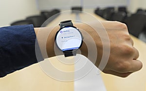 Business man look smartwatch at meeting room show agenda schedule when where and organizer