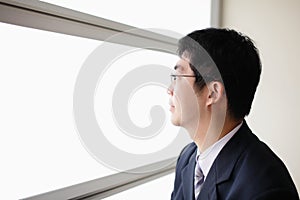 Business man look through window