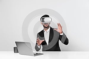 Business man looking at data while sitting and wearing VR glasses. Deviation.