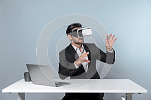 Business man looking at data while sitting and wearing VR glasses. Deviation.