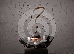 Business man looking at question mark sketch