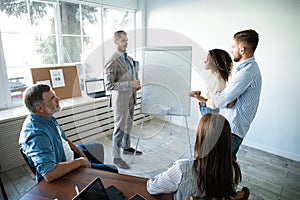 Business man making a presentation at office. Business executive delivering a presentation to his colleagues