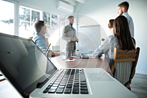 Business man making a presentation at office. Business executive delivering a presentation to his colleagues